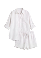 Oversized white linen co-ord set with a button-up shirt and drawstring shorts.
