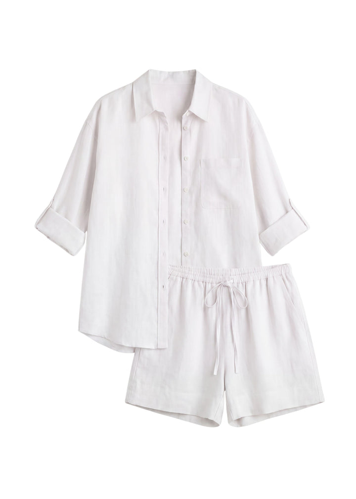 Oversized white linen co-ord set with a button-up shirt and drawstring shorts.