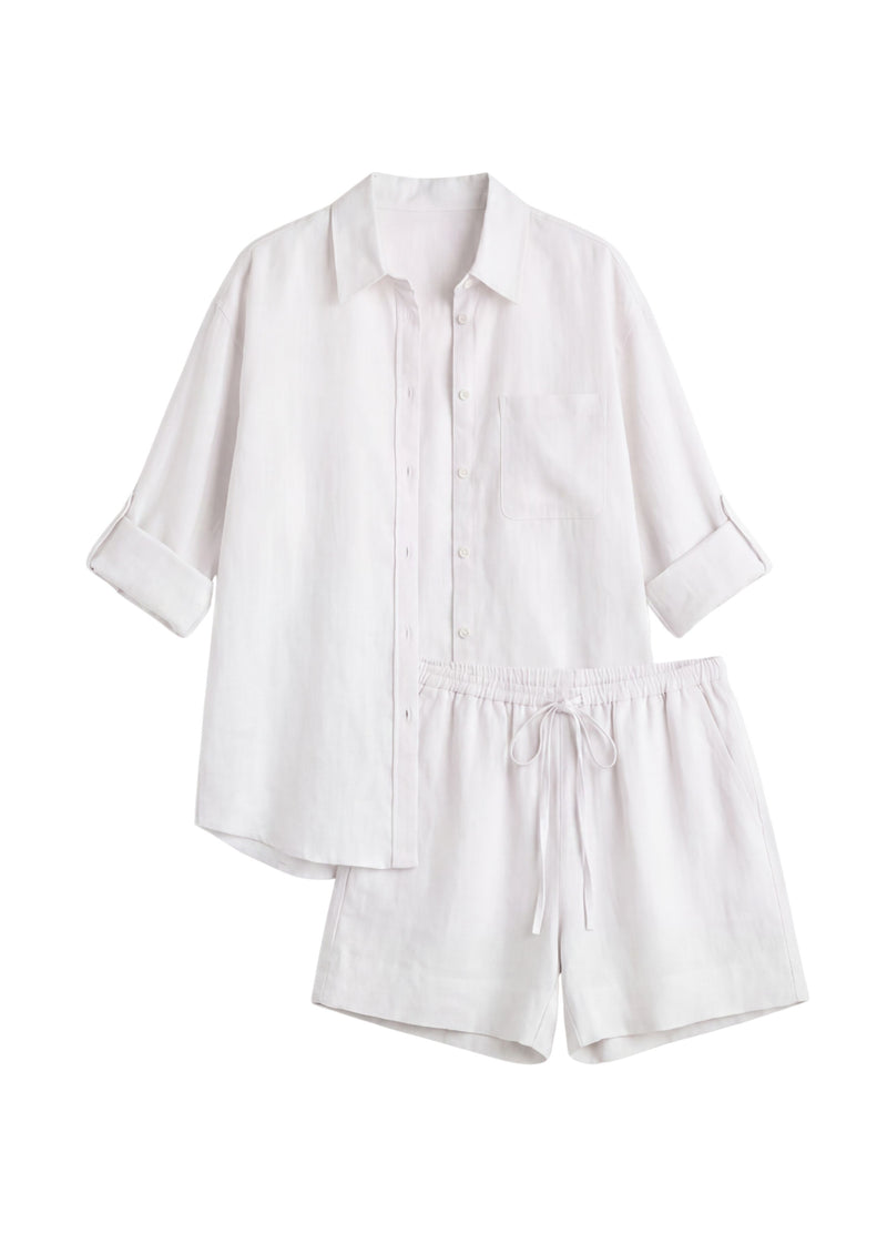 Oversized white linen co-ord set with a button-up shirt and drawstring shorts.