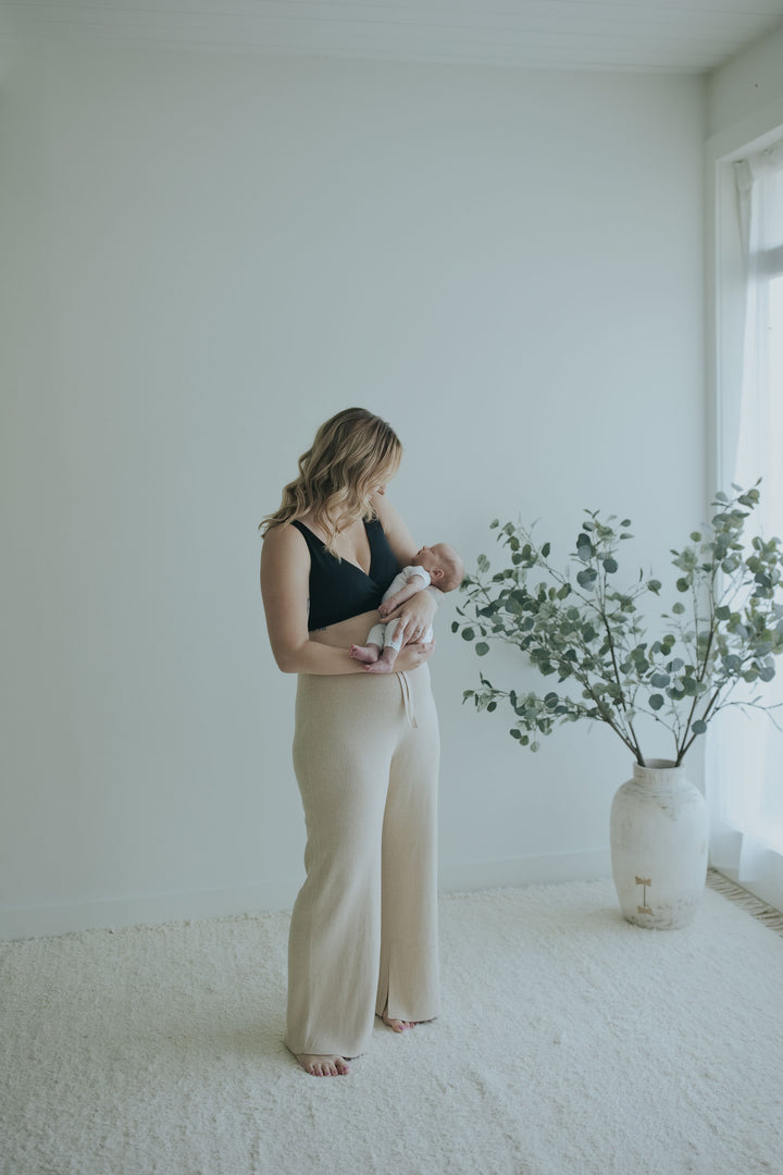 Woman in the Oatmeal Ribbed Knit Wide-Leg Pants, full length three-quarter view