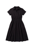 Black cotton poplin Sarah shirt dress with short sleeves, collar, and shirred elastic waist.