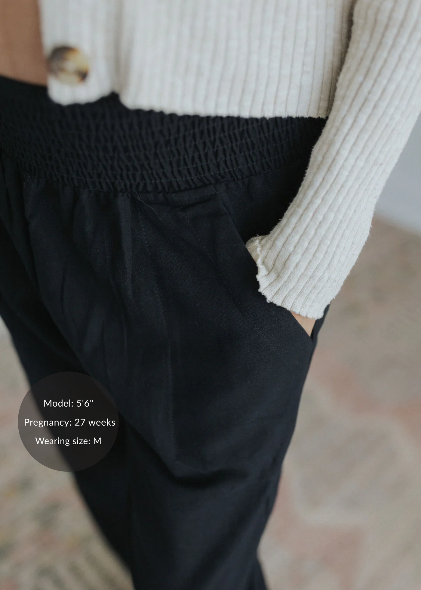 Black straight leg maternity trousers in cotton/linen blend, featuring a smocked elastic waistband and side pockets.