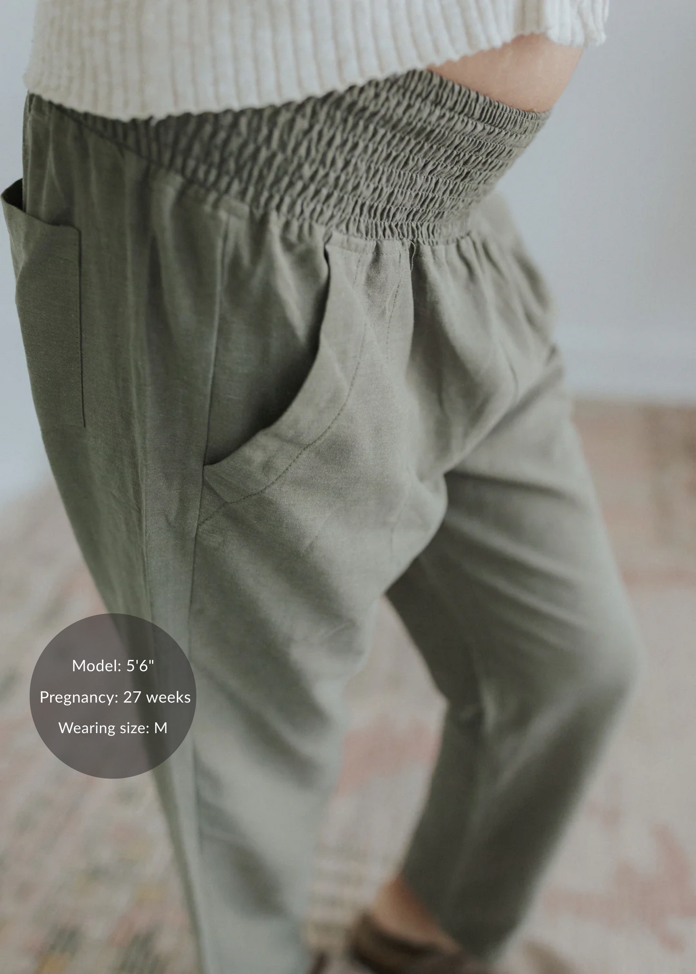 Olive green straight leg maternity trousers in cotton/linen blend, featuring a shirred elastic waistband and side pockets.