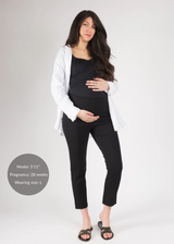 Pregnant woman in black Dressy Stretch Ponte Pants, black top, and white shirt.