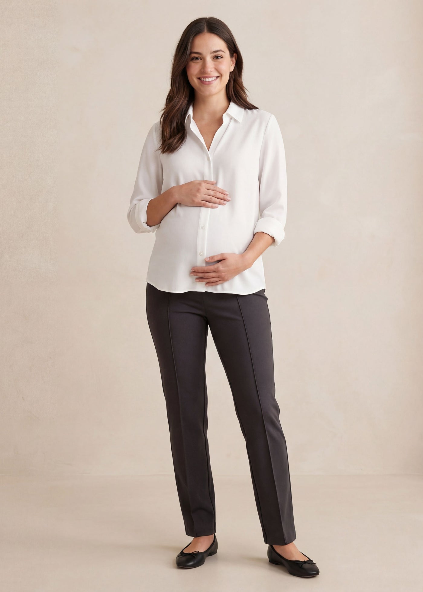 Smiling pregnant woman in a white blouse and dark gray Dressy Stretch Ponte Pant.