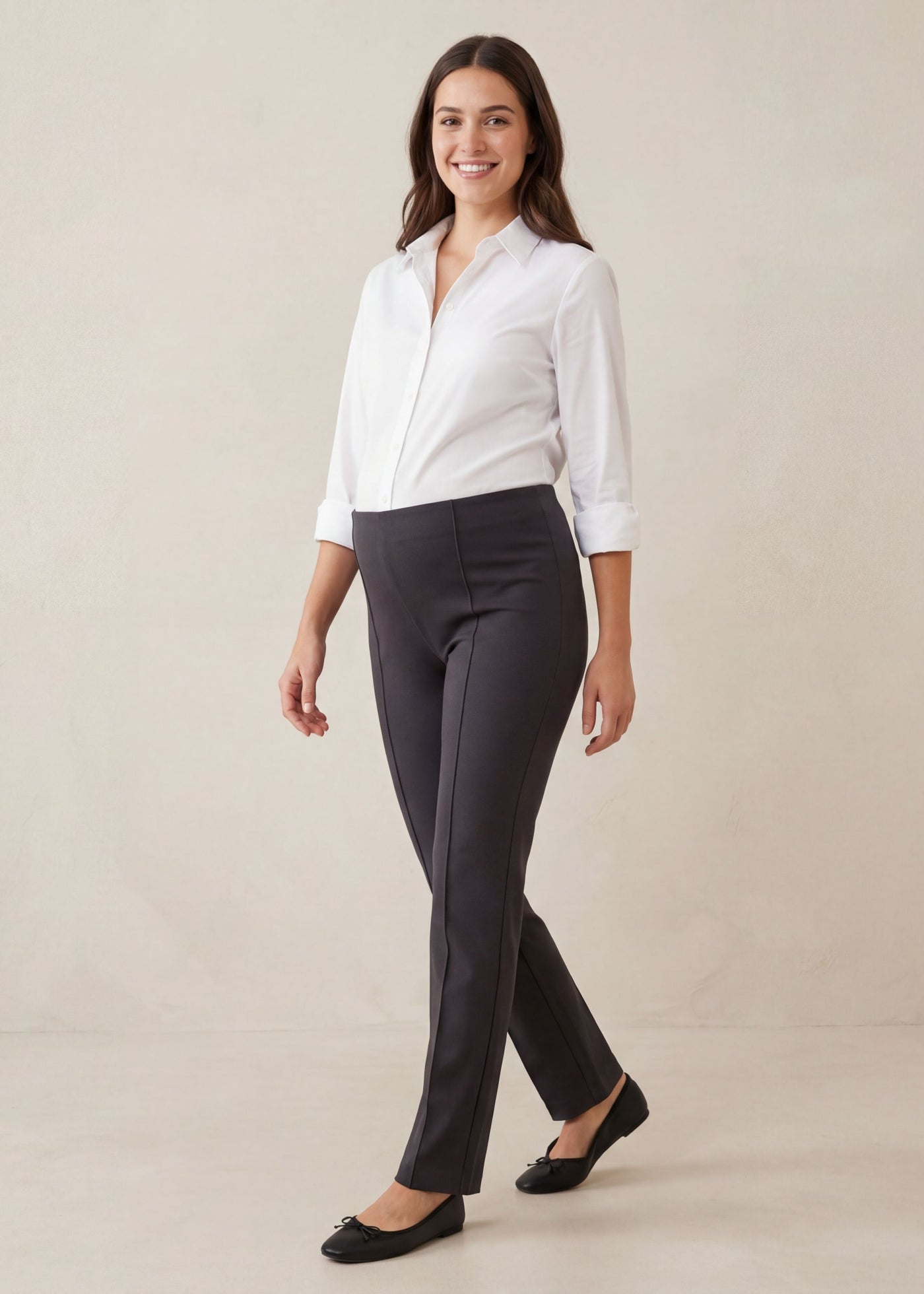 Smiling pregnant woman in a white shirt and dark gray Dressy Stretch Ponte Pant with a flat elasticized waistband.