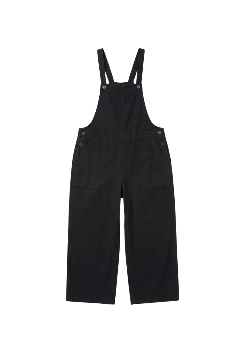Black linen/cotton Journey Overalls with adjustable straps, side buttons, and deep front pockets.