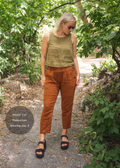 Woman in Everyday Breeze Pant in rust cotton gauze with elastic waistband and pockets.