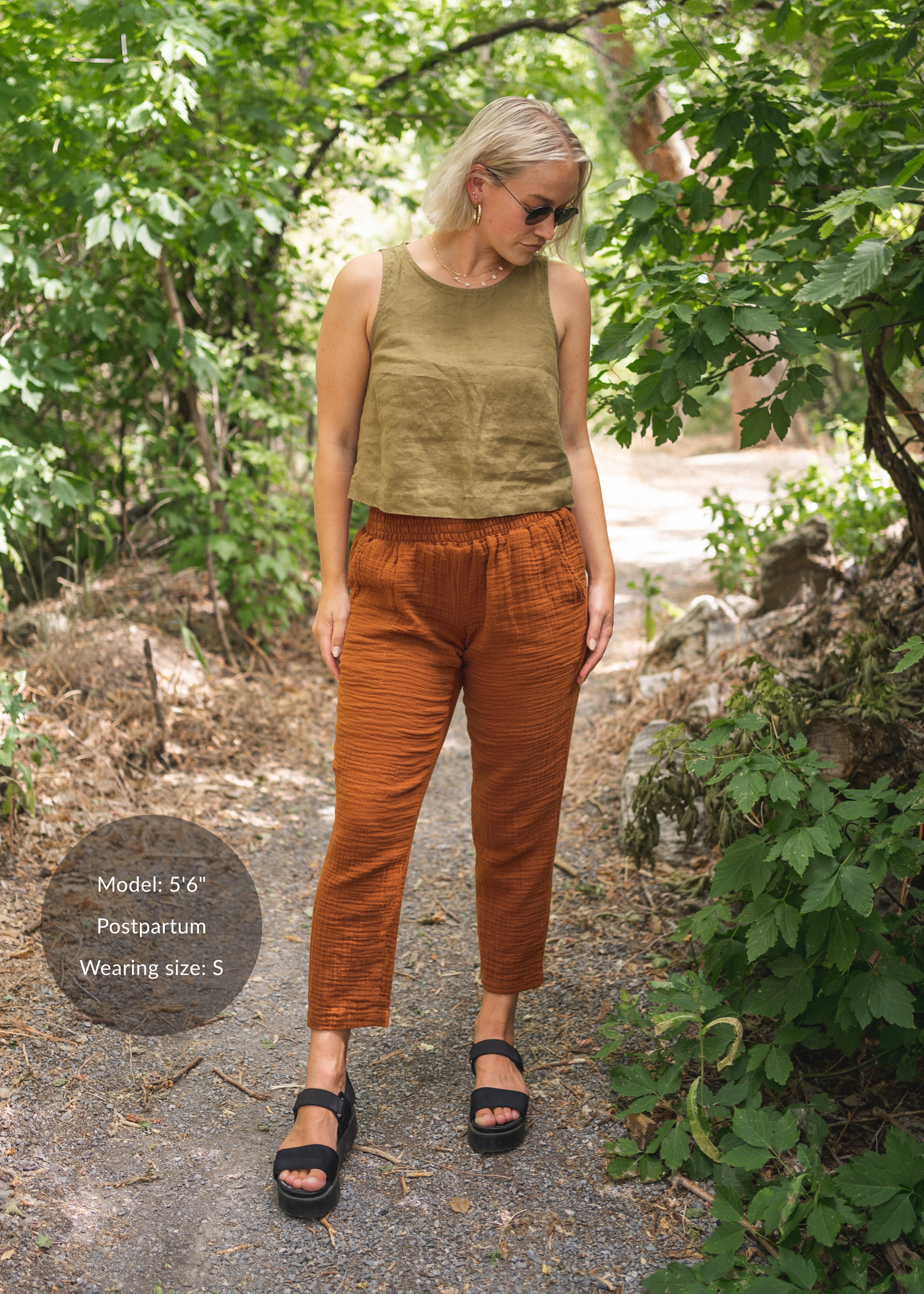 Woman in Everyday Breeze Pant in rust cotton gauze with elastic waistband and pockets.