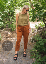 Woman in Everyday Breeze Pant in rust cotton gauze with elastic waistband and pockets.
