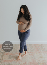 Pregnant woman in Everyday Breeze navy cotton gauze pants with elastic waistband and pockets.