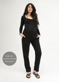 Tall pregnant woman in black linen smocked-waist maternity pants with pockets.