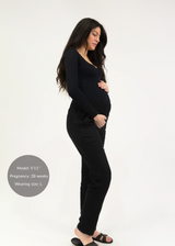 Pregnant woman in black linen smocked maternity pants, extended inseam, size L.