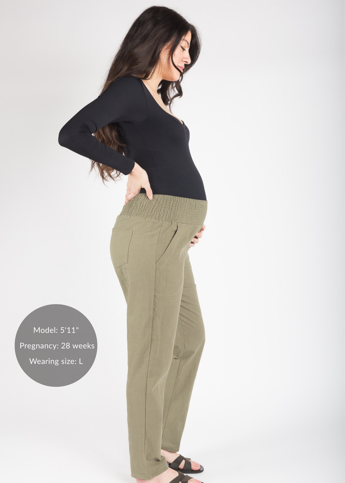 Woman in olive green linen pants with a smocked waistband.