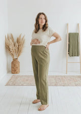 Model wearing the Transitional Straight Leg Smocked Pant in Reedcloth in Olive — smocked waistband maternity pant