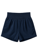 Navy blue cotton/linen smocked shorts with deep front pockets and an elastic waistband.