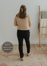 Pregnant woman wearing black Dressy Stretch Ponte Pants with a contoured waistband.