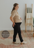 Pregnant woman in black Dressy Stretch Ponte Pants with a contoured waistband.