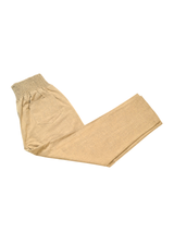 Folded everyday transitional smocked linen pants in a natural tan color with functional pockets.