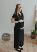 Pregnant woman in a black cotton poplin waist-gathered dress, size S.