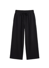 Black cotton fleece wide-leg lounge pants with a drawstring waist and side pockets.