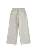 Light beige wide-leg flow pants in cotton/linen blend, featuring an elastic waist and side pockets.