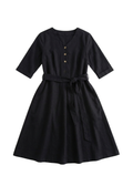 Black cotton-linen Willow Dress with V-neck, button-down front, adjustable waist tie, and flared knee-length skirt.