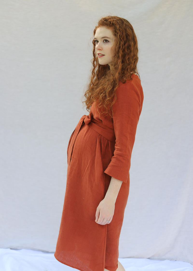 The Faye Dress in softened linen, close on the V-neck and front button placket.