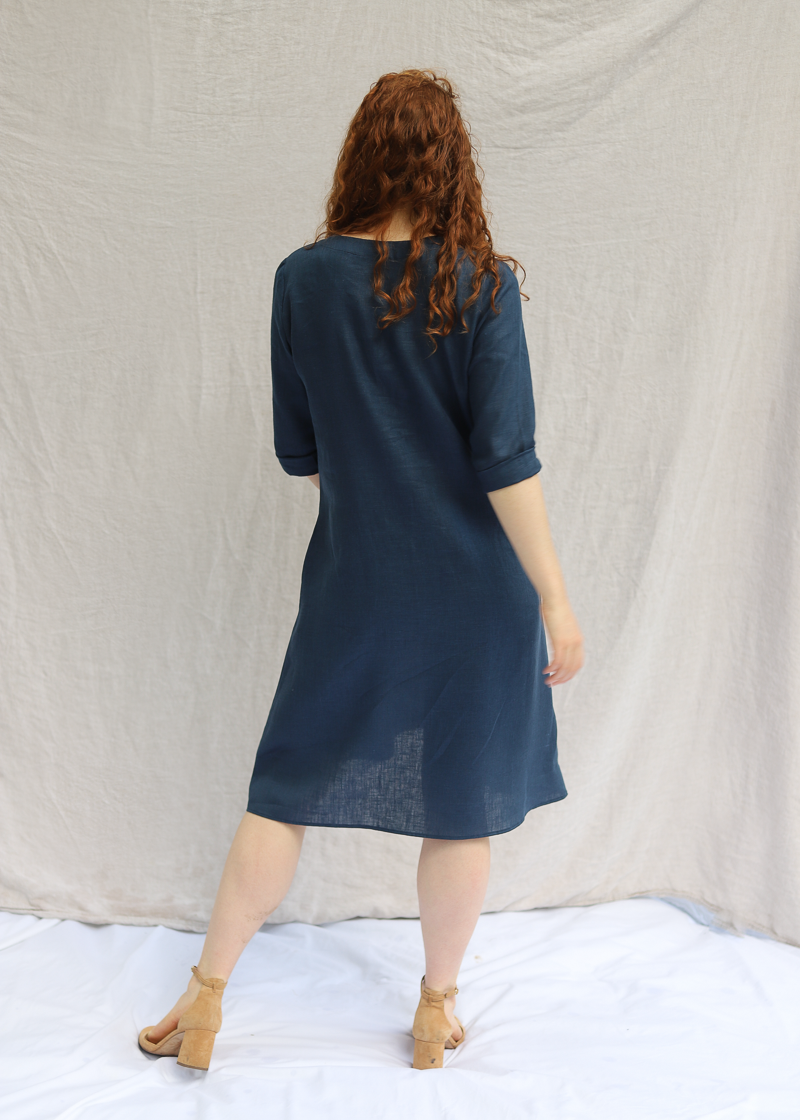 The Faye Dress in softened linen, worn with the waist tie loose.
