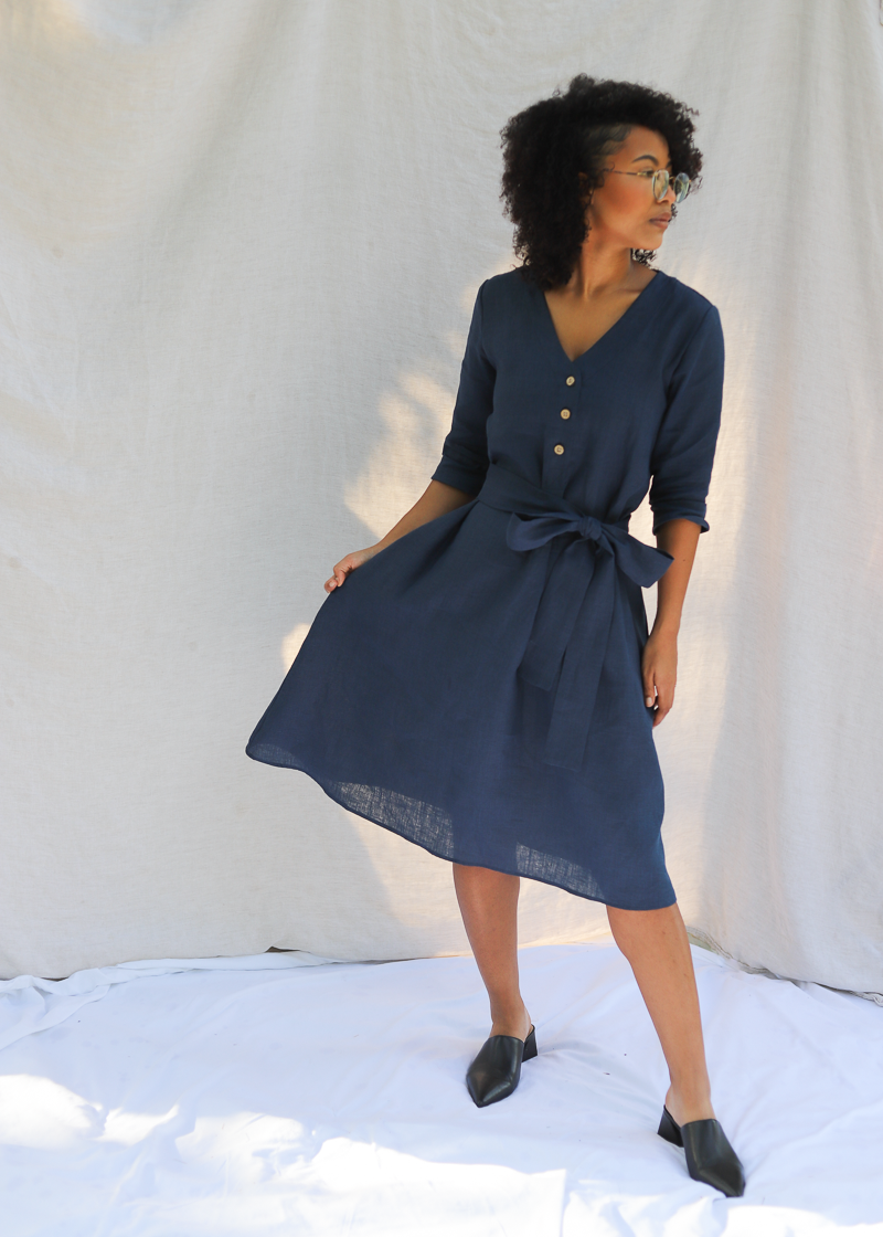 The Faye Dress in softened linen, V-neck with front buttons and a waist tie.