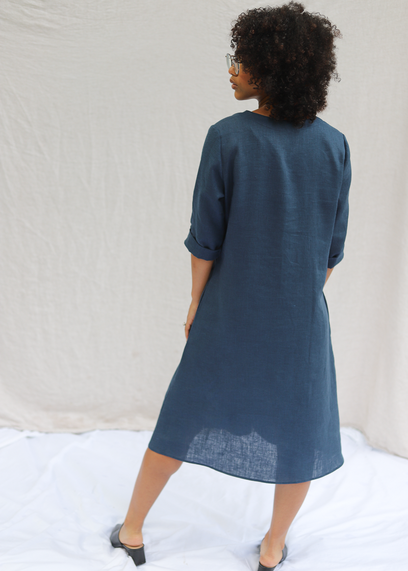 The Faye Dress in softened linen, relaxed through the body with side pockets.