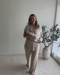 Mom wearing the Nursing Cover in Cotton Cashmere as a top, then pulling it over her baby to nurse