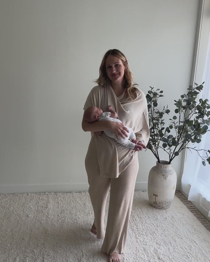 Mom wearing the Nursing Cover in Cotton Cashmere as a top, then pulling it over her baby to nurse