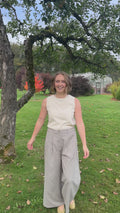 Woman walking and turning in the Gray Adjustable Wide Leg Dress Pant, showing front, side and back