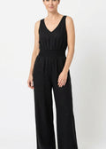 Smocked-Waist V-Neck Linen Jumpsuit in Linen in Black — on model