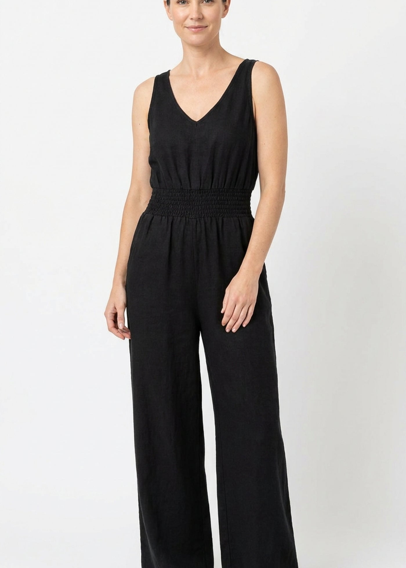 Smocked-Waist V-Neck Linen Jumpsuit in Linen in Black — on model