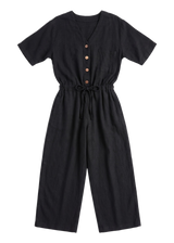 The Easy On/Off Jumpsuit in black sandwashed linen, laid flat.