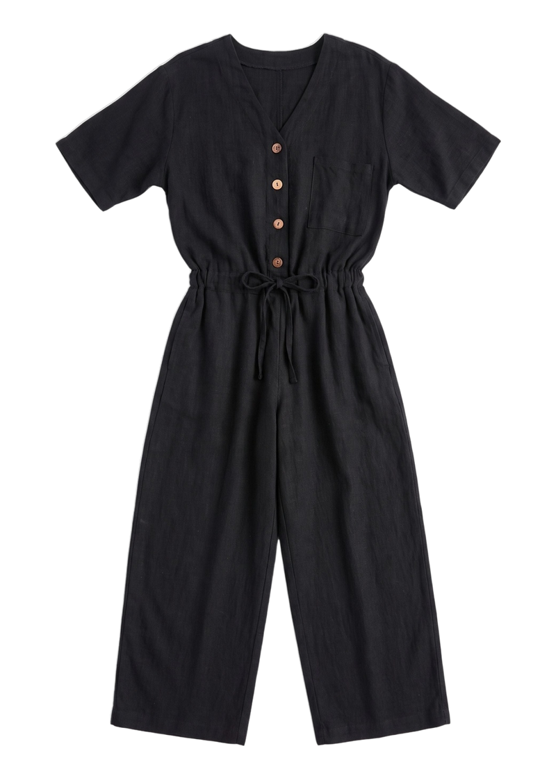 The Easy On/Off Jumpsuit in black sandwashed linen, laid flat.