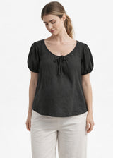 Tie-Neck Puff-Sleeve Cropped Linen Blouse in Linen in Black — on model